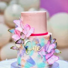 A beautiful two-tiered cake for a first birthday party, decorated with butterflies. I love capturing the details of milestone celebrations, including the all-important birthday cake.
