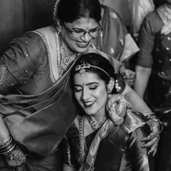 A tender moment between the bride and her mother, captured in classic black and white. The lack of color emphasizes their expressions and the emotional connection they share.
