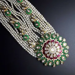 If heritage could be explained in one piece, this would be it. This traditional Polki haar, with its intricate meenakari work and layers of pearls, is crafted to feel like a family heirloom from the very first day you wear it.