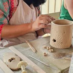 A student adding creative cutouts to a hand-built lantern. Corporate workshops are always filled with laughter and amazing ideas.