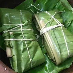 Freshly wrapped Pollichathu parcels, tied with string and ready for the pan. This traditional method ensures all the flavors of the spices and the juices of the fish are sealed inside.