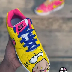 A full view of our Homer Simpson themed Nike sneaker. The bright yellow shoe features Homer eating a donut, with his classic "WOOHOO" quote on the side.