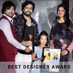 Receiving the Best Kids Designer award from actress Mugdha Godse and my guru ji. Having my work in children's couture recognized is incredibly special to me.