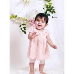 Celebrating a big milestone. This photo captures the excitement of a baby standing on her own for the first time, a precious memory for any parent.