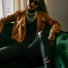 Mixing grunge with glamour. This shot pairs a biker jacket and leather trousers with timeless pearls, showing my flair for unexpected styling combinations.