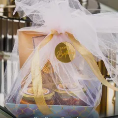 Our hampers are perfect for every occasion, from birthdays to anniversaries. This beautifully wrapped gift box includes a 'Happy Birthday' sticker, showing how we tailor each hamper to your celebration.