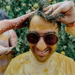 The groom getting his fair share of Haldi. These ceremonies are all about fun, family, and real, messy emotions, and we design the space to encourage it all.