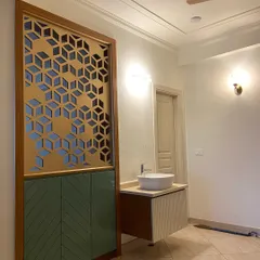 This unique piece combines a decorative partition with a vanity area. It features a CNC-cut panel, a floating vanity with a vessel sink, and a storage cabinet with chevron-patterned doors.