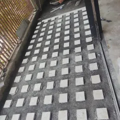 To promote sustainability, this balcony floor is being finished using waste stone from the site. The small squares are set in a grid pattern for a textured, modern look.