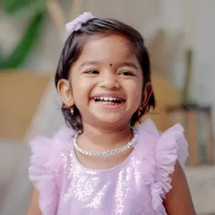 A close-up portrait of a toddler's infectious, happy laugh. This studio shot captures the genuine expression and personality of a young child, highlighting my ability to connect with kids and make them feel comfortable.