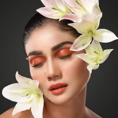 Another shot from the "Bloom" series, this portrait uses soft lilies and warm makeup tones to create a peaceful, ethereal mood. It shows my ability to create different feelings within a single creative concept, from bold to serene.