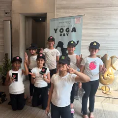 A happy group of kids celebrating International Yoga Day at our studio. We foster a sense of community and fun in our children's classes.