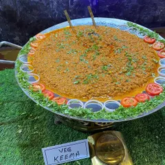 Our special Veg Soya Keema, a rich and spicy minced soya dish, garnished with onions and tomatoes.