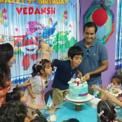 The big moment! Here, the birthday star, Vedansh, is surrounded by friends and family as he blows out the candles on his amazing Super Wings themed cake. We create a special space for these cherished memories.