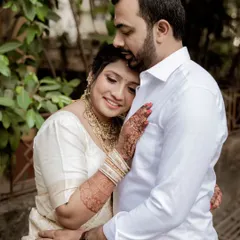 A tender moment between a South Indian couple. The bride rests her head on the groom's chest, a simple gesture that speaks volumes about their comfort and love for each other.
