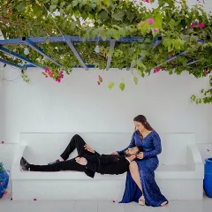 A relaxed and romantic moment under a canopy of bougainvillea. Priyanshi sits as Yash lays his head in her lap, a perfect picture of love in a beautiful, serene setting.