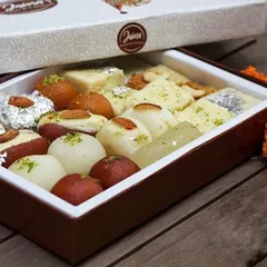 Our assorted mithai boxes are perfect for any celebration, especially Diwali. This box features a mix of Gulab Jamun, Rasgulla, Kalakand, and other favourites, starting from just Rs 340 per kg.