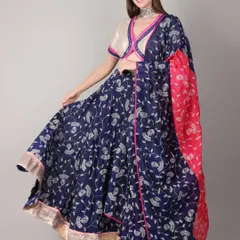 For Navratri, we created this royal blue lehenga set, perfect for a vibrant dandiya night. The flowing skirt allows for beautiful movement, while the off-white blouse with pink and blue mirror work trim adds a playful contrast. It’s a complete look that balances traditional charm with festive energy.