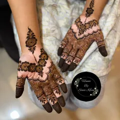 This is a lovely example of a simple party mehendi design. It features a floral 'bel' or vine on one hand, with a complementary motif on the other for a balanced look.