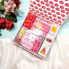 I created this pretty pink hamper for a client's fiancée. It's filled with a variety of handmade goodies, including a shaker card, a mini album, and cute pun-filled matchbox notes.