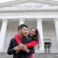 A joyful piggyback moment captured in front of the historic Asiatic Society in Mumbai. This image showcases our ability to blend playful couple portraits with grand, architectural backgrounds for a timeless feel.