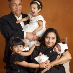 A multi-generational portrait filled with joy and laughter. Capturing grandparents with their new grandchild is one of my greatest honors, preserving a legacy of love.