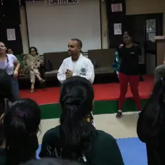 The atmosphere in my workshops is interactive and engaging. Here, I'm working with participants, ensuring everyone feels comfortable and involved in the learning process.