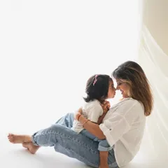 An incredibly sweet and intimate moment between a mother and her daughter, nose to nose. The minimalist setting allows their bond to be the star of the show.