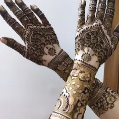 A full-coverage design that tells a story. This intricate mehendi features delicate floral work on the forearm and classic mandala patterns on the palm, all coming together for a truly stunning look.
