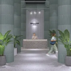 The welcoming entrance to the GRASSROOT retail store. The design uses fluted columns, terrazzo counters, and lush greenery to create a bright, natural, and calming atmosphere that invites customers to explore.