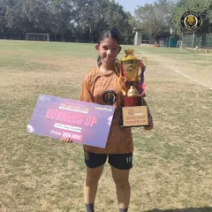 One of our players proudly displays the runners-up trophy and prize check from the JMF Pink Cup tournament.
