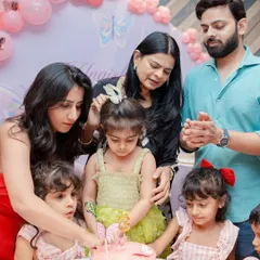 A family gathered around to help the birthday girl cut her butterfly cake. These are the sweet, shared moments that I love to be a part of.