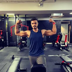 Consistency is key. A post-workout bicep flex, showing the muscle definition that comes from dedicated and consistent arm training sessions.