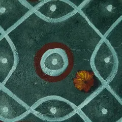 A close-up detail of the kolam mural. You can see the texture of the wall and the hand-painted quality of the lines and dots, which gives the piece an authentic, rustic feel inspired by traditional South Indian floor art.