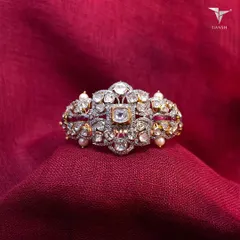 This festive season, let this polki bracelet be your companion for all cherished moments. The intricate design features a central uncut diamond surrounded by smaller polkis and pearls.