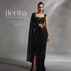 The Hertha Concept Saree Set is a fierce and subtle statement. This full view shows the pre-draped concept saree with a high slit, paired with a hand-adorned corset blouse for a look that is both powerful and elegant.