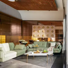 This view of the living area in the Tranquil Mango Haven shows the material palette I chose to create a calm atmosphere. The terracotta tile ceiling and wood paneling add warmth, while the grey stone floor provides a cool, grounding element that connects to the outdoor hardscaping.
