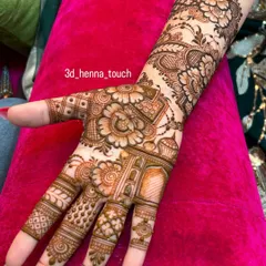 A close-up of a dense Indo-Arabic design. The combination of shaded flowers, delicate leaves, and geometric patterns on the fingers and palm showcases a high level of detail.
