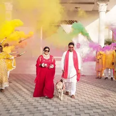 A grand entrance with color bombs and a furry friend. I love capturing unique and personal touches that make your Haldi ceremony special.