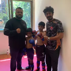 With our wrestling coach and two of our young fighters. We have a team of dedicated coaches to provide specialized training in different aspects of MMA.