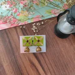 The same gotapatti and jhumki design, this time in a vibrant parrot green. These earrings are lightweight and perfect for adding a festive touch to your look.
