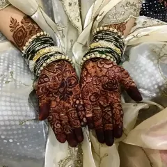 The final stain is everything. This photo shows the rich, reddish-brown color my natural henna develops into after a couple of days, beautifully complemented by the bride's traditional bangles.