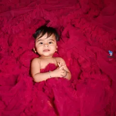 This little girl is surrounded by a sea of beautiful pink tulle fabric. A simple but very effective concept.
