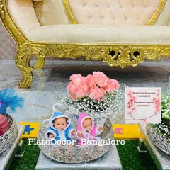 This arrangement for a twin baby shower includes a basket of fresh pink roses and two baby dolls. It’s a sweet and elegant way to present gifts for the mother-to-be.