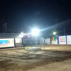 A "before" shot of the kindergarten grounds at night, just before my team started the transformation.