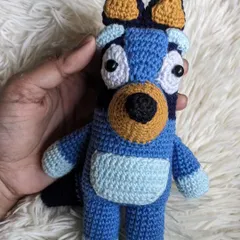 A handmade crochet doll of Bluey, the lovable character from the children's show.