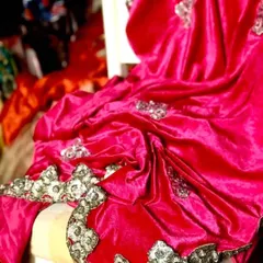 A luxurious fuchsia velvet saree with hand-embroidered borders and bootas. The lycra velvet drapes beautifully for a slimming effect, making it a rich and glamorous must-have for the winter wedding season.