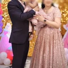 We have outfits for the whole family, whether you're hosting a party or attending one. This coordinated set features a sparkling pink gown for mom, a matching frock for the baby, and a complementary suit for dad.