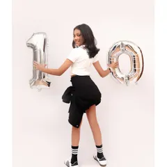 Turning ten in style. I also do milestone photoshoots for older kids, capturing their personality with fun props like these large number balloons.