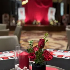Another look at our casino night centerpieces, this time featuring a glass vase filled with dice alongside the red candle and roses. This small detail reinforces the theme in a playful yet elegant way.